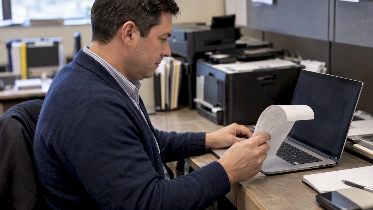 Administrator comparing fax and digital records